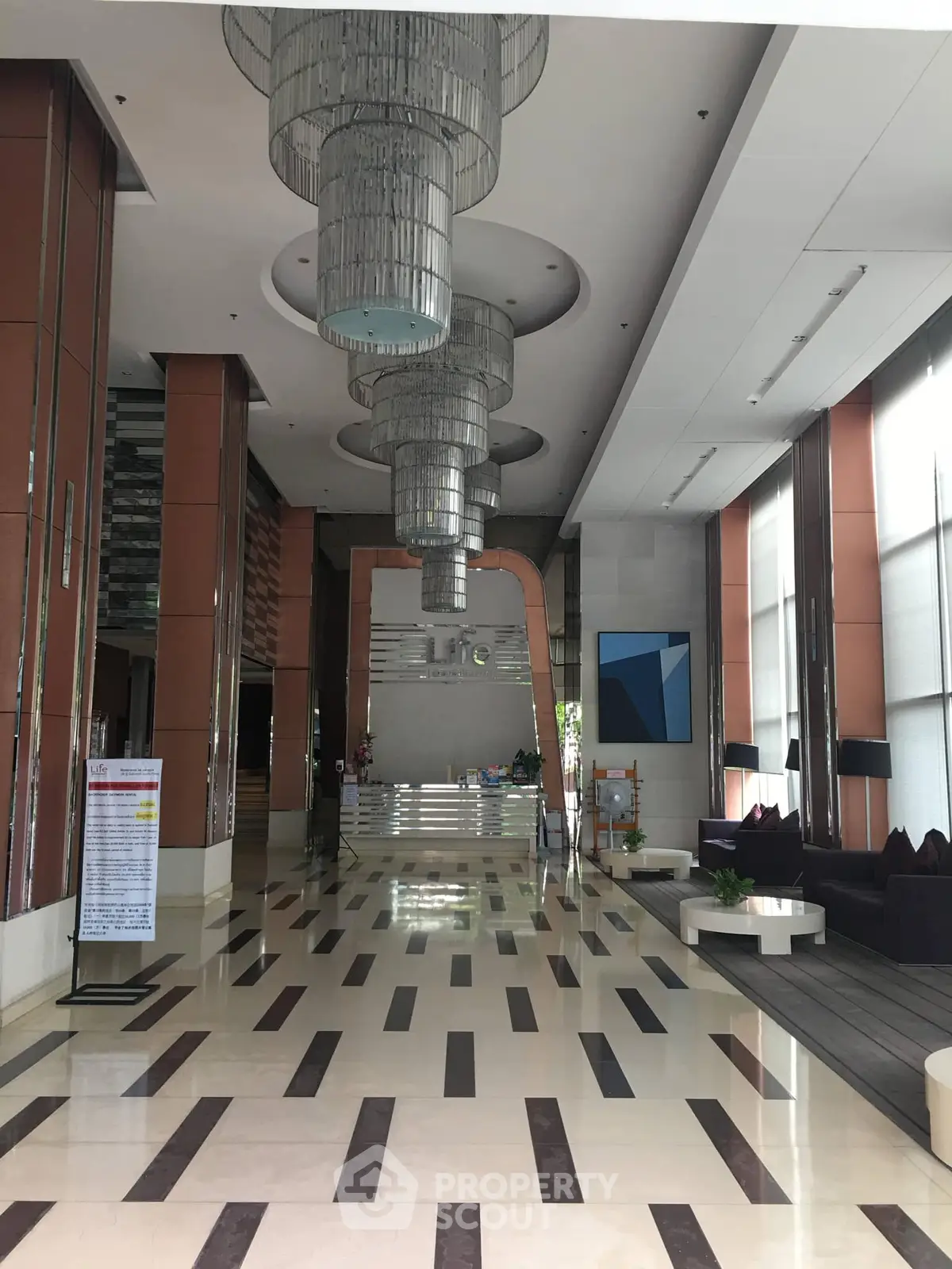 Luxurious building entrance with modern chandeliers and sleek design