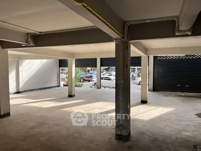 Spacious commercial space with large windows and street view, ideal for retail or office setup.
