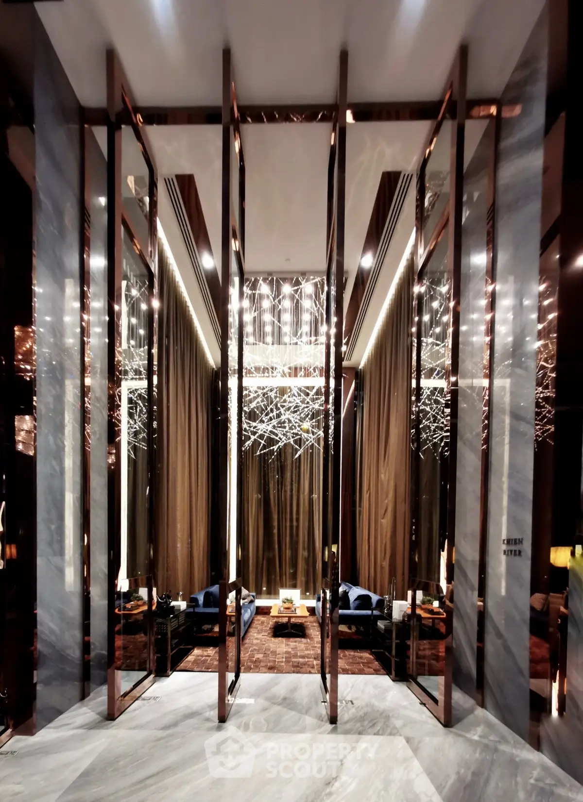Luxurious modern lobby with elegant lighting and plush seating in a high-end building.