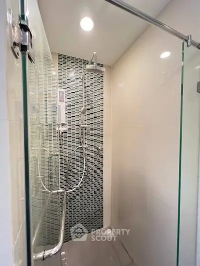 Modern bathroom with glass shower enclosure and stylish tile design