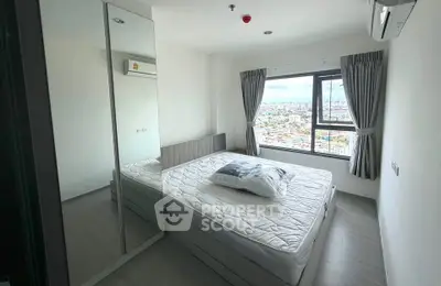 Modern bedroom with large window offering stunning city views, featuring a comfortable bed and sleek mirrored wardrobe.