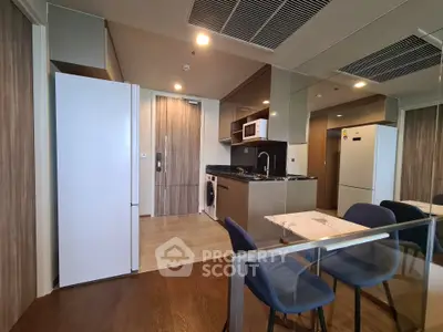 Modern kitchen with sleek appliances and dining area in a stylish apartment