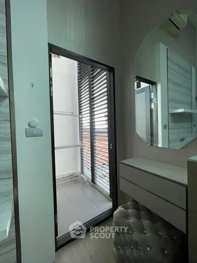 Modern interior with a small balcony, featuring sleek design and contemporary furnishings.