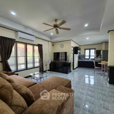 Spacious living room with open kitchen and modern furnishings