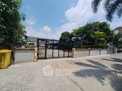 Spacious vacant lot with gated entrance, ideal for development in a serene neighborhood.