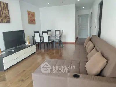 Spacious living room with modern furniture and dining area, perfect for family gatherings.