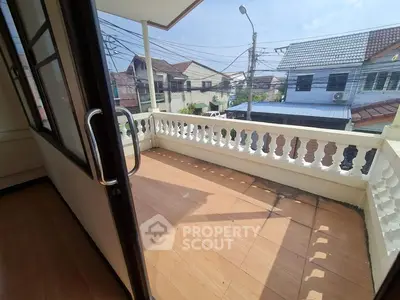 Spacious balcony with tiled flooring and street view in residential area