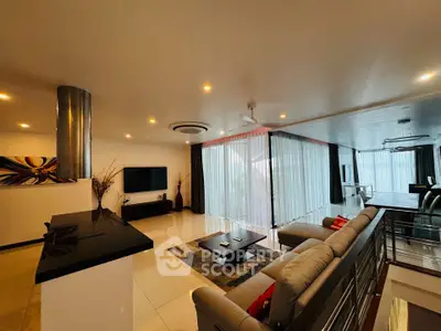 Luxurious open-plan living room with modern decor and ample natural light