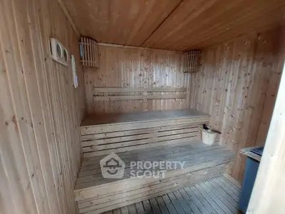Luxurious wooden sauna interior with tiered seating and warm ambiance