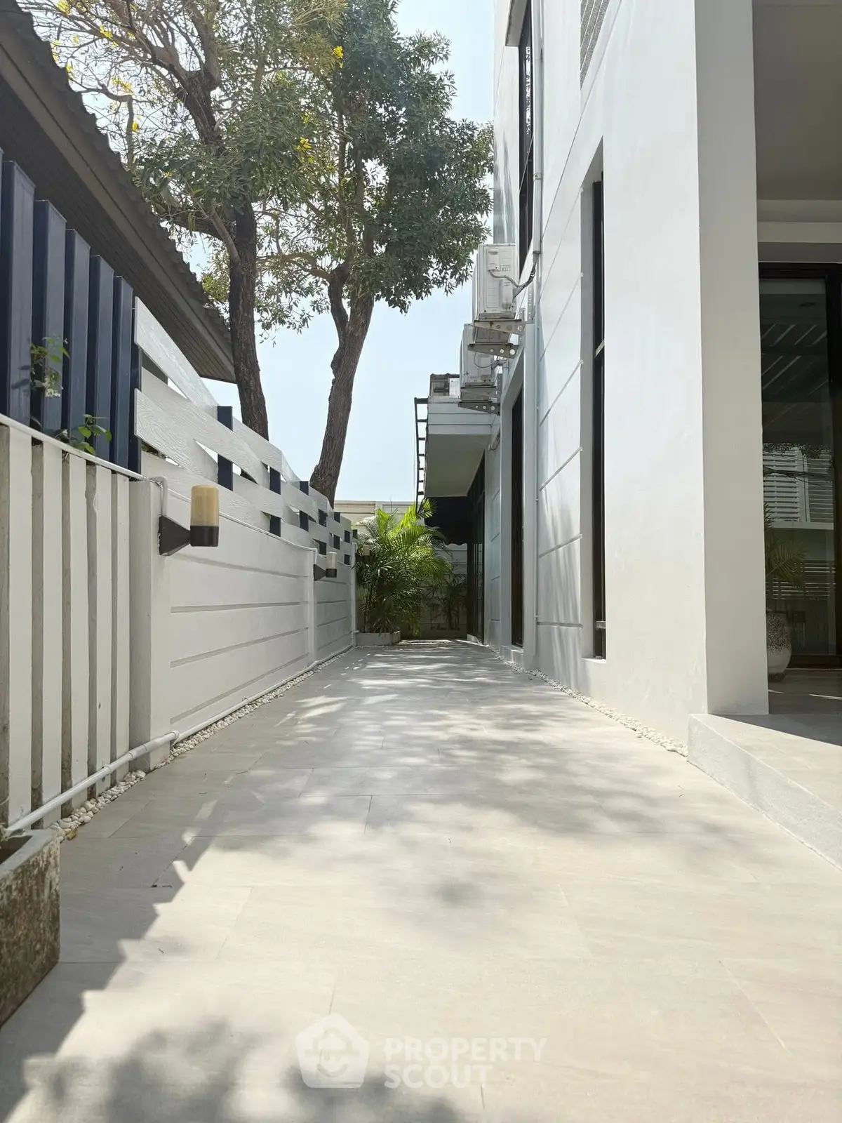 Modern exterior walkway with sleek design and lush greenery