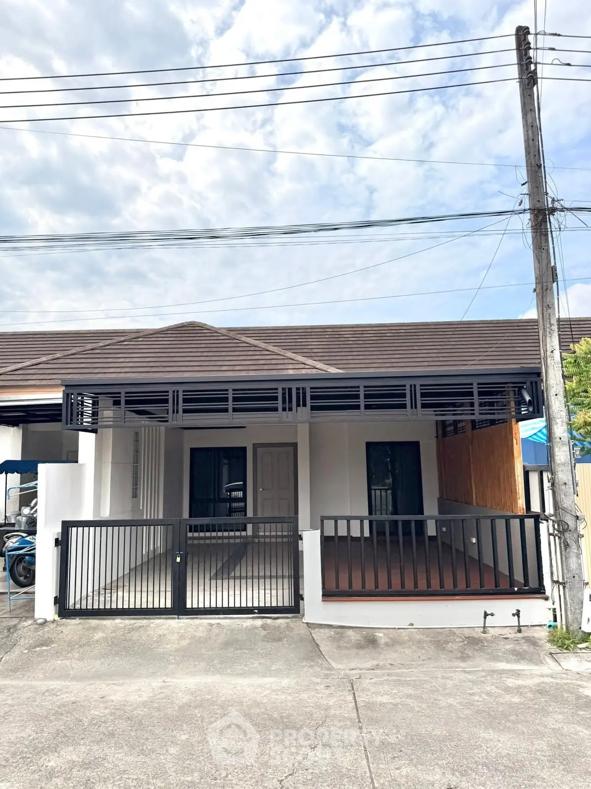 Charming single-story home with modern facade and gated entrance