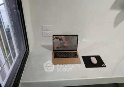 Modern study nook with marble desk and window view