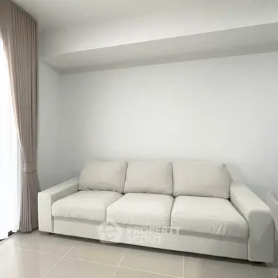 Spacious modern living room with elegant white sofa and natural light