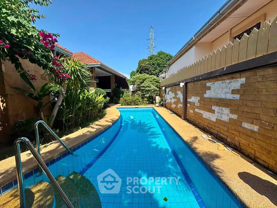 Charming private pool area with lush greenery and serene ambiance, perfect for relaxation and leisure.