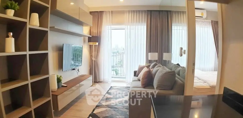 Modern living room with stylish decor and balcony view in a cozy apartment.