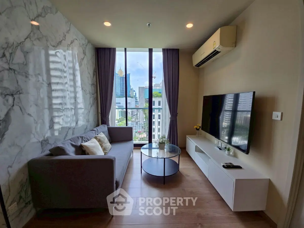 Modern living room with city view, stylish decor, and natural light