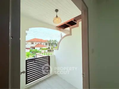 Charming balcony with stylish railing and overhead light, offering a cozy outdoor space.