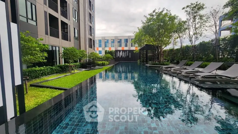 Luxurious condominium pool area with modern design and lush greenery