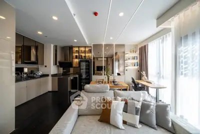 Luxurious modern living room with open kitchen, stylish decor, and abundant natural light.
