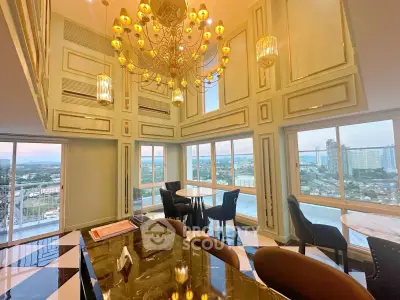 Luxurious high-rise living room with panoramic city views and elegant chandelier.