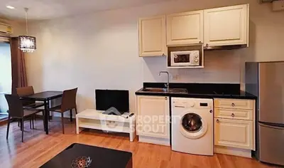 Charming open-layout kitchen with modern appliances and cozy dining area in a stylish apartment.