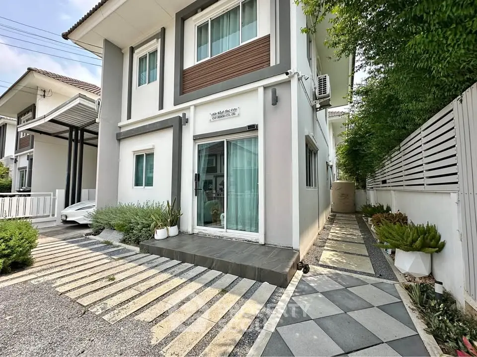 Modern two-story house with sleek exterior and landscaped walkway in a serene neighborhood.