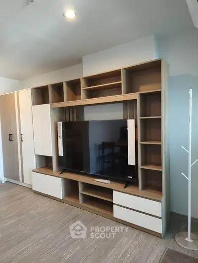 Modern living room with stylish wooden entertainment center and TV