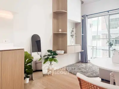 Modern living room with natural light, stylish decor, and cozy seating area.