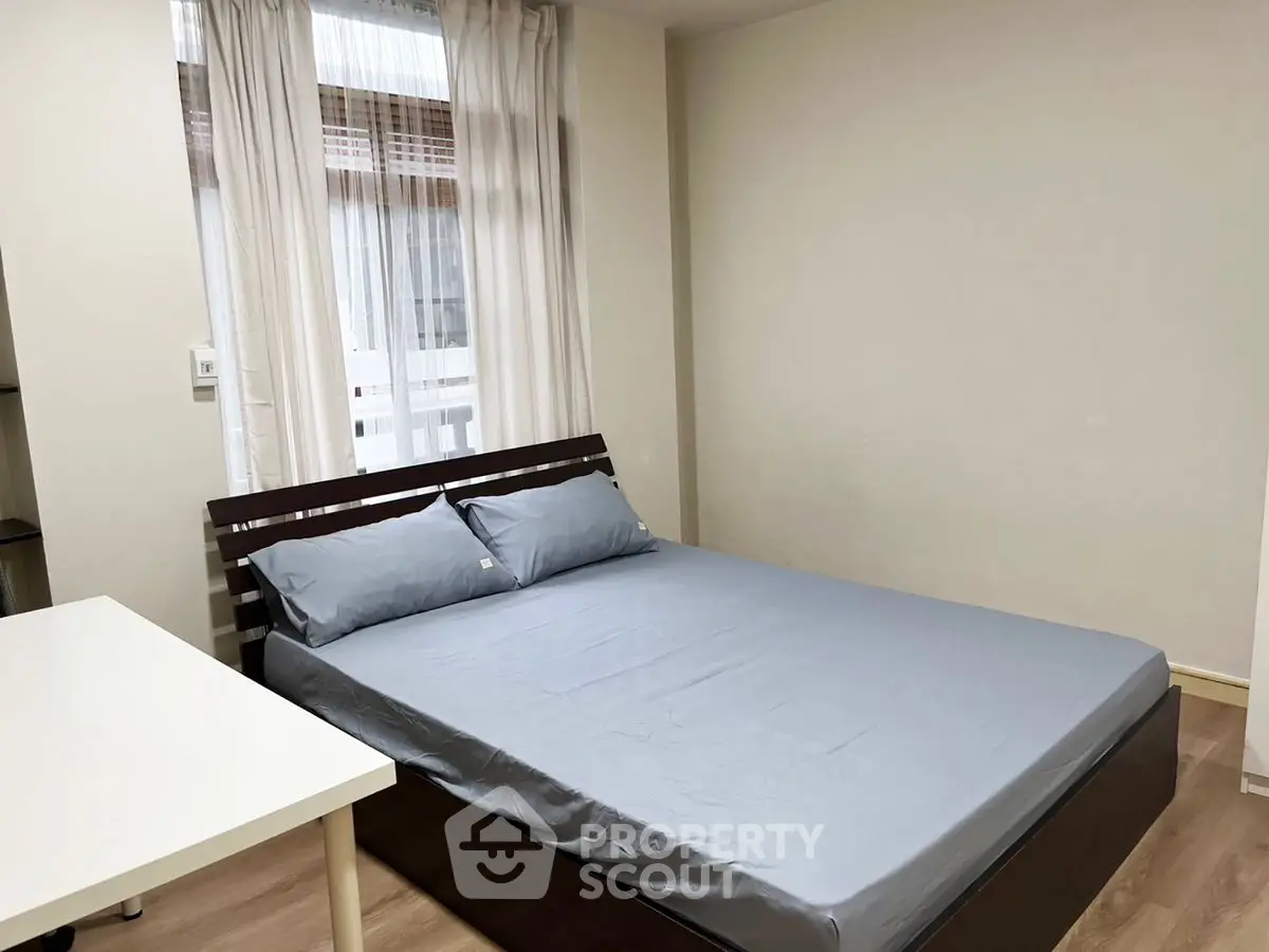 Cozy bedroom with modern bed and natural light, perfect for restful nights.