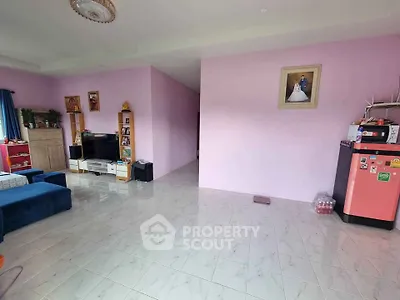 Spacious living room with modern decor and ample natural light, perfect for family gatherings.