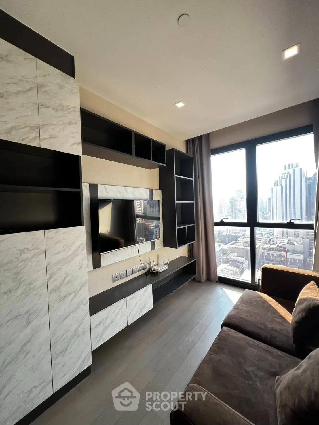 Modern living room with stylish shelving and city view