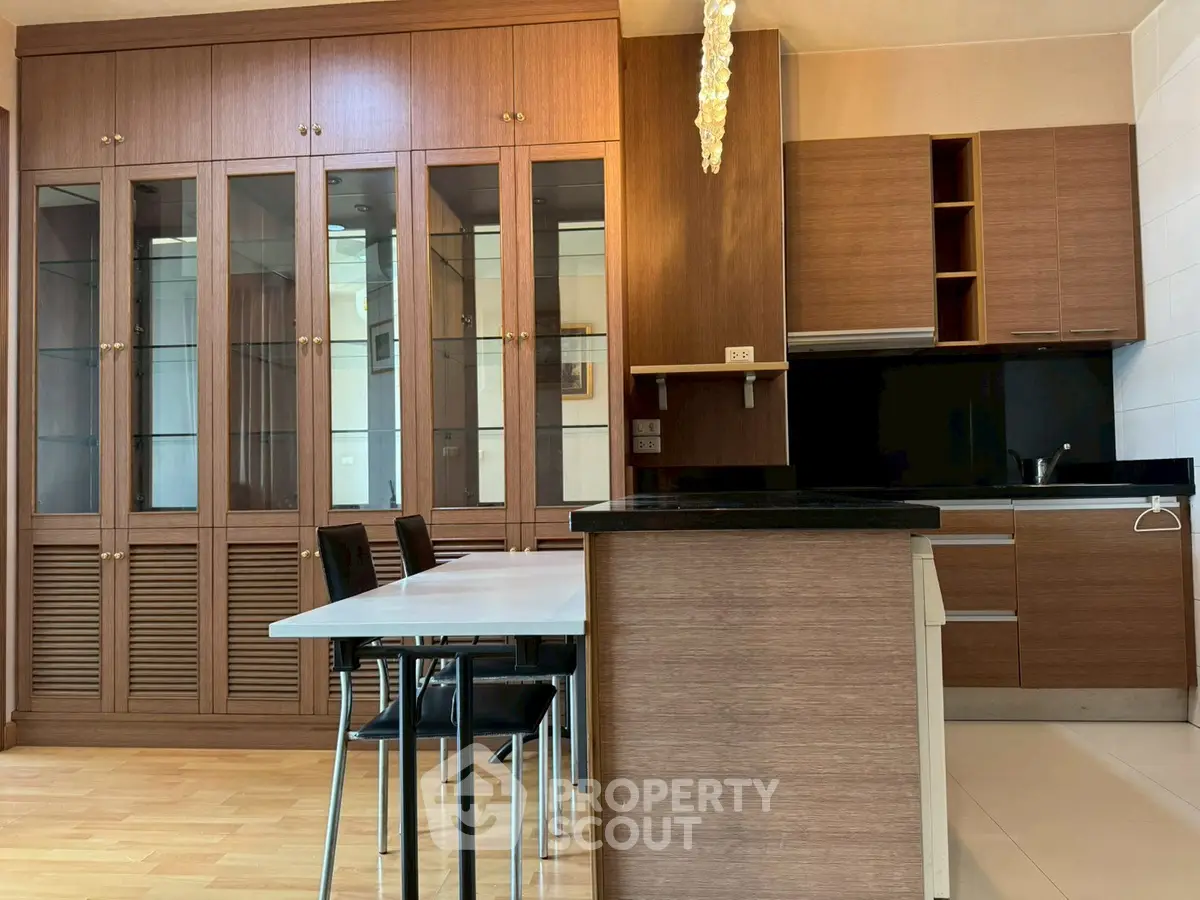 Modern kitchen with wooden cabinets and sleek black countertops