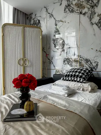 Luxurious bedroom with marble accent wall and elegant decor