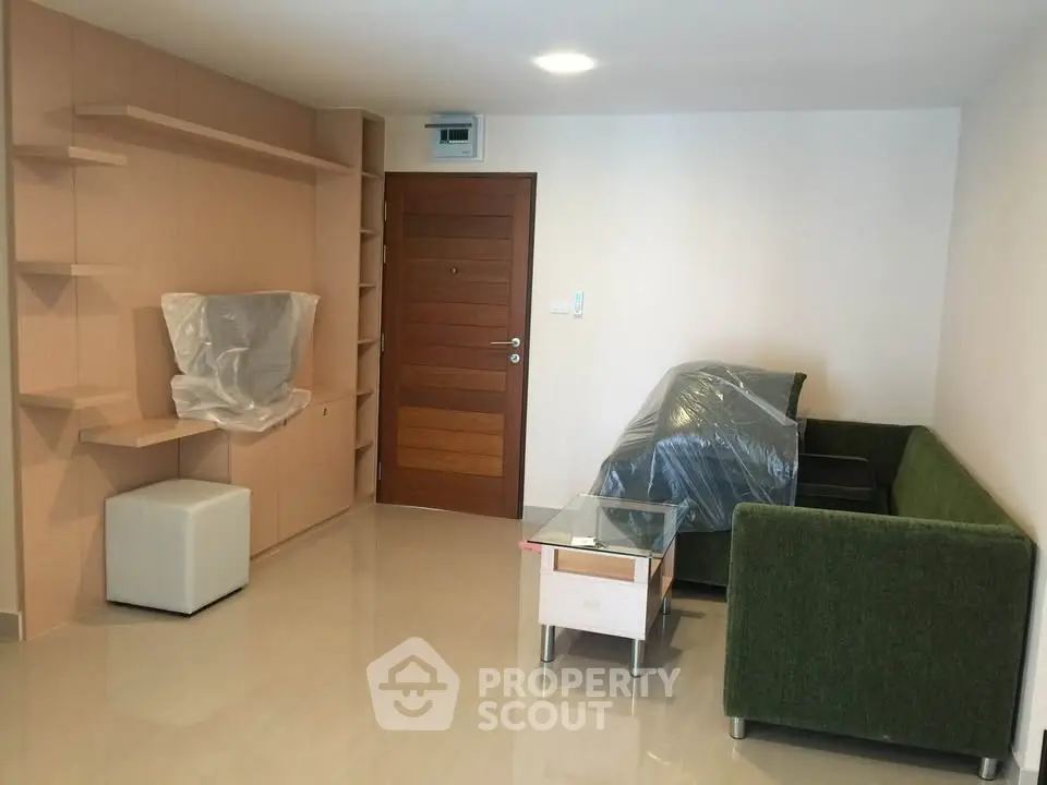 Modern living room with green sofa and wooden accents, perfect for cozy gatherings.