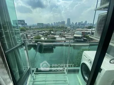 Stunning balcony view with river and cityscape, featuring a washing machine for convenience.