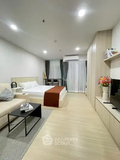 Modern studio apartment with cozy living area and stylish decor