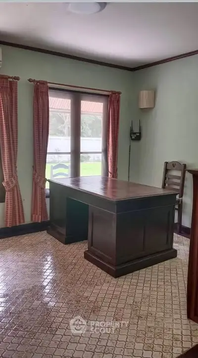 Charming study room with classic wooden desk and elegant curtains, perfect for a home office setup.