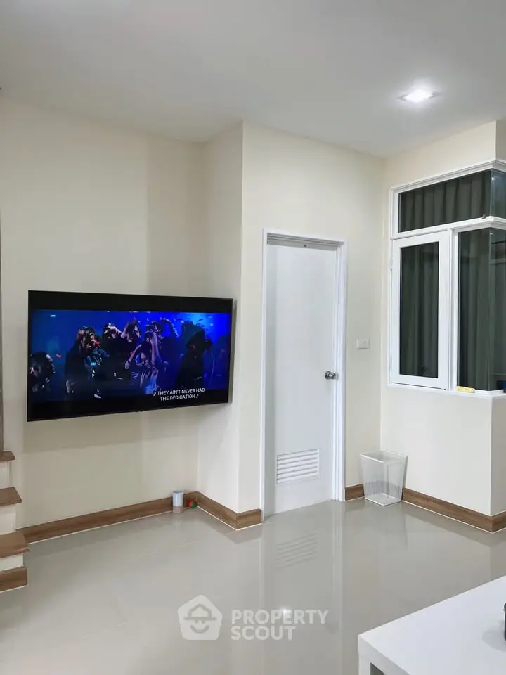 Modern living room with wall-mounted TV and sleek design
