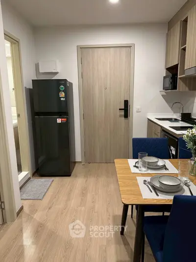 Modern kitchen with dining area and sleek appliances in a stylish apartment