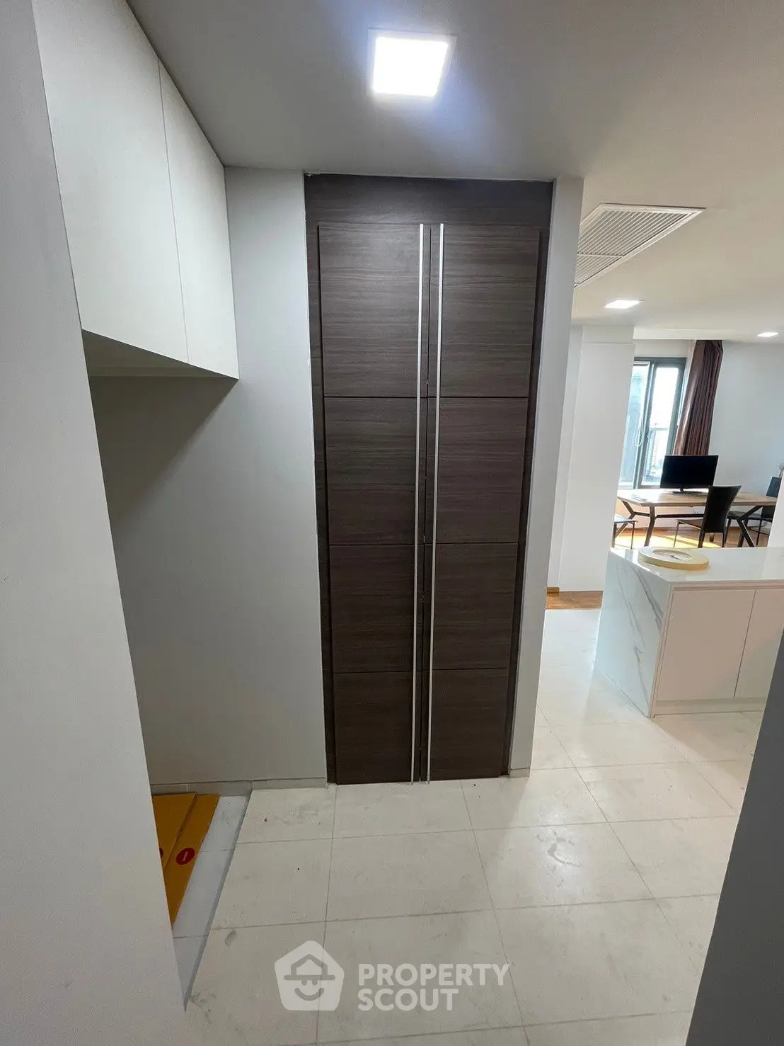 Modern apartment hallway with sleek storage and open layout