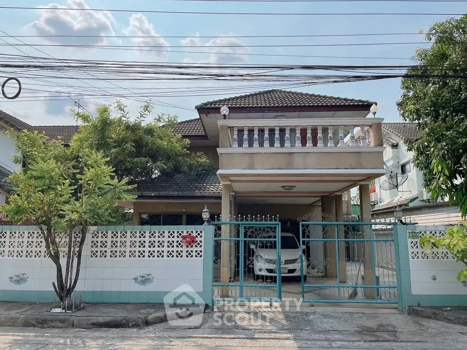 Charming suburban house with gated entrance and carport, ideal for family living.
