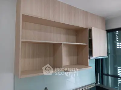 Modern kitchen with sleek wooden cabinets and glass backsplash