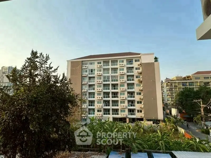 Scenic view of modern apartment building with lush greenery