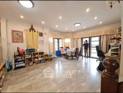 Spacious living room with modern decor and ample natural light, perfect for family gatherings.