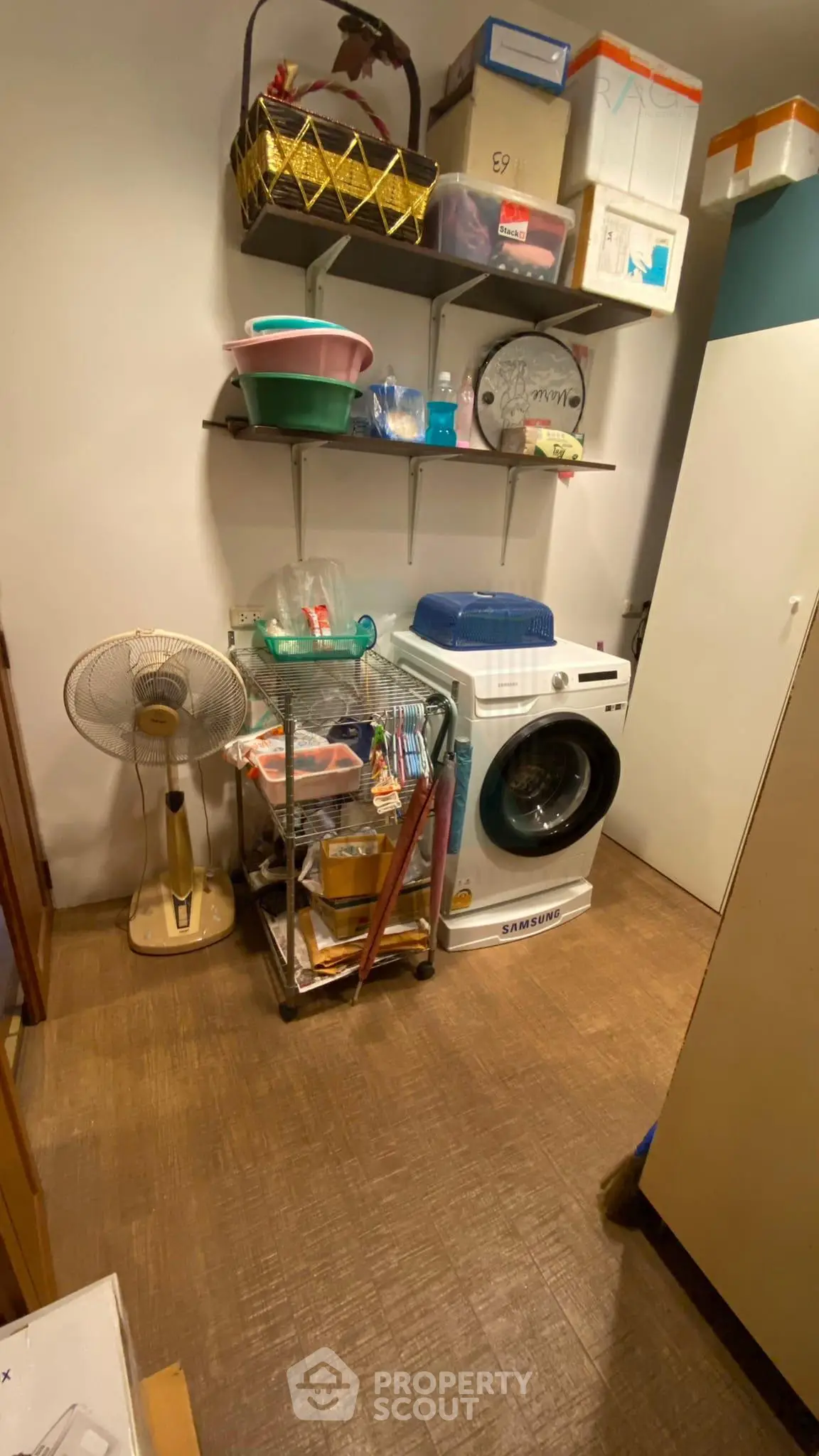 Cozy storage room with washing machine and organized shelves in a modern home.