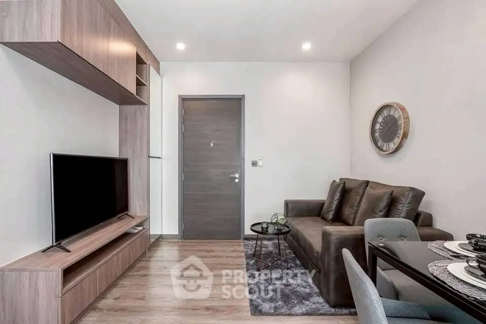 Modern living room with sleek furniture and wall-mounted TV, perfect for urban living.