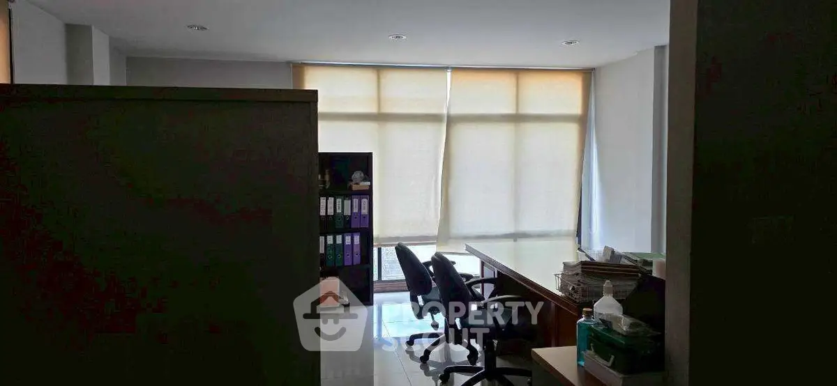 Spacious office space with natural light and modern furnishings, ideal for productivity and comfort.