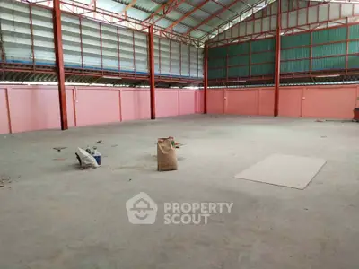 Spacious industrial warehouse with high ceilings and ample storage potential.