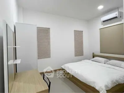 Modern minimalist bedroom with sleek furniture and air conditioning