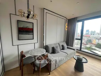 Modern living room with city view, featuring stylish decor and cozy seating area.
